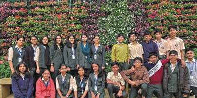 Students in front of flower wall in Ooty