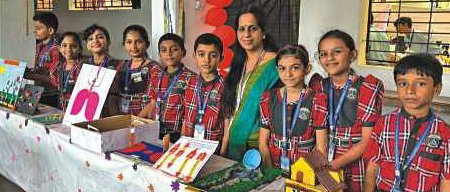 Teacher and students at science project stall