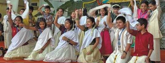 Students performing Onam dance with shawls