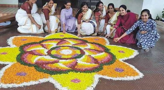 Teachers around Onam flower carpet