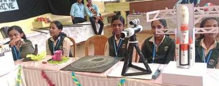Students displaying space rocket model