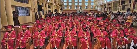 Kindergarten graduates seated in graduation robes