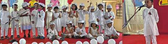 Boys in white outfits with roses on stage